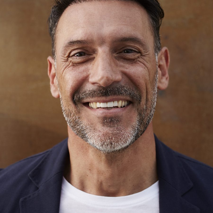middle aged man wearing jacket laughing happy x