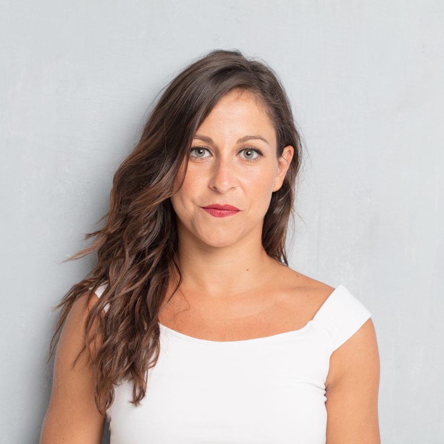 young pretty woman posing against cement wall background with s x